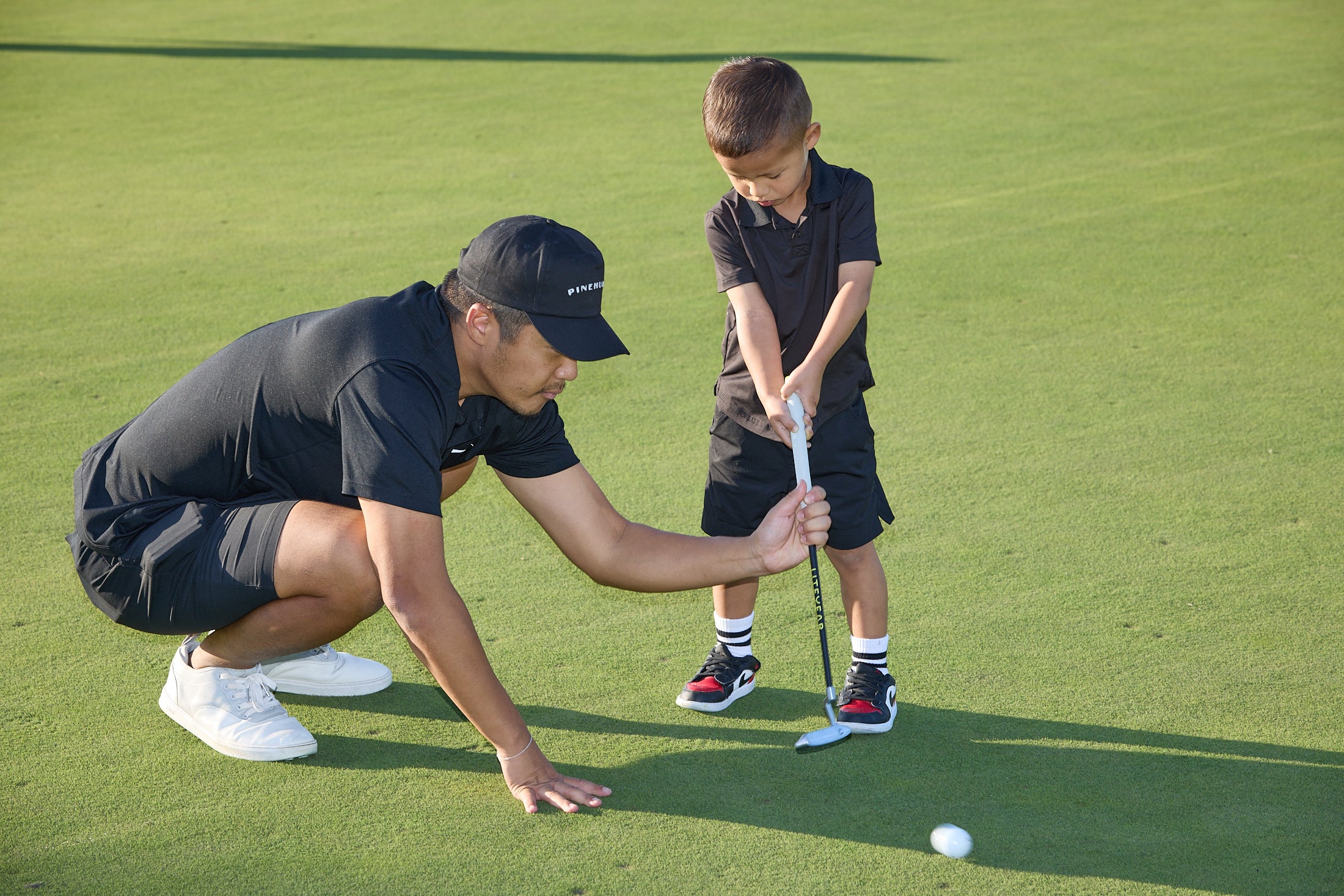 Father teaching child to put
