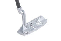 Golf putter with a silver head and black shaft on a white background