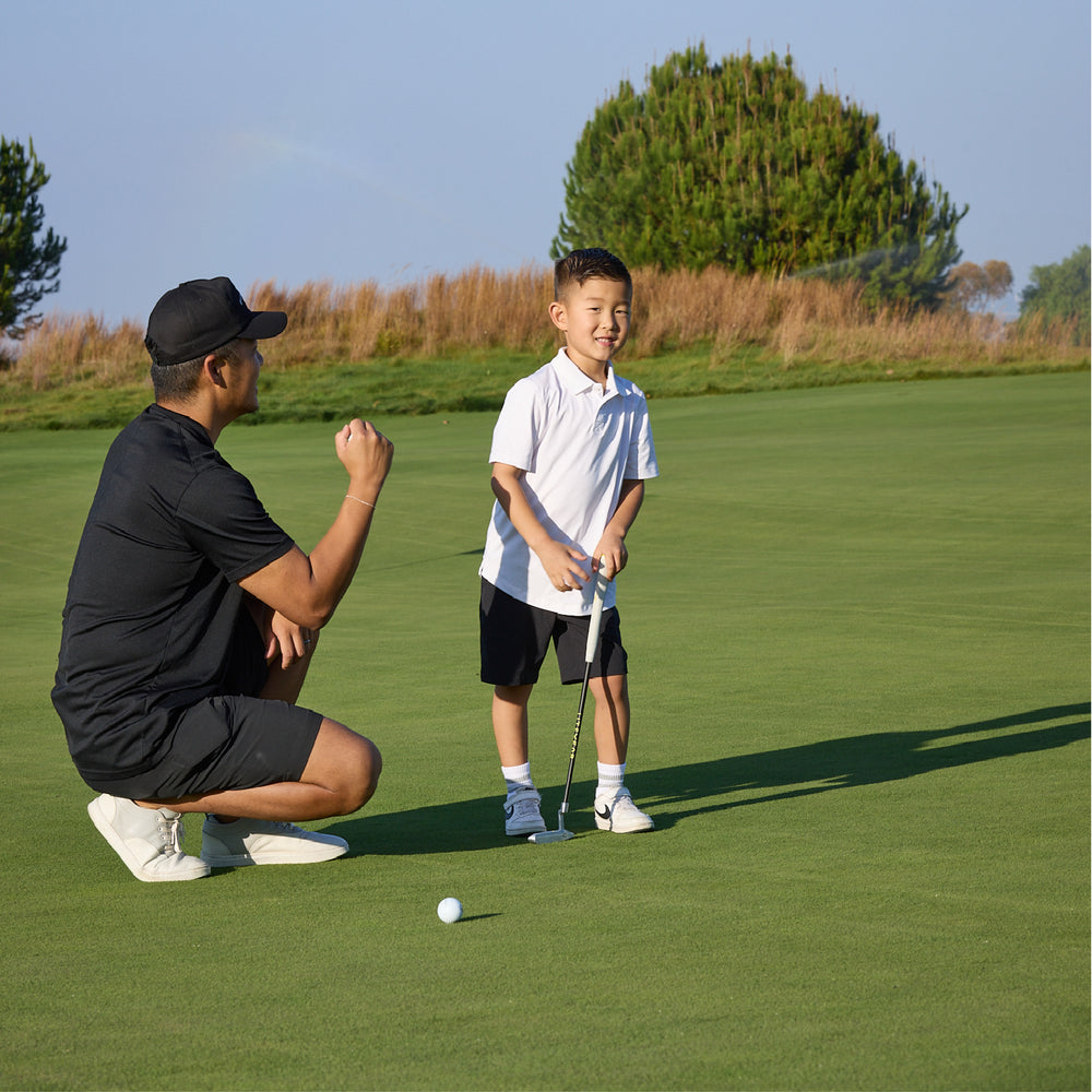Dad and son putting